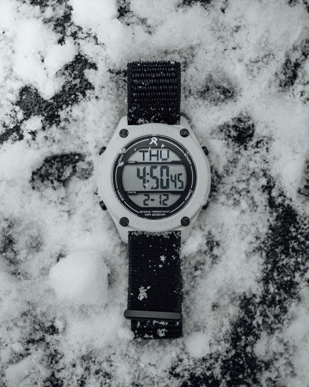 White RZE UTD-8080-ST digital watch worn on the wrist